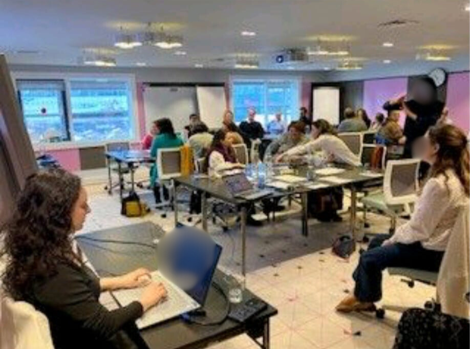 Céline tape à l'ordinateur dans une salle de réunion