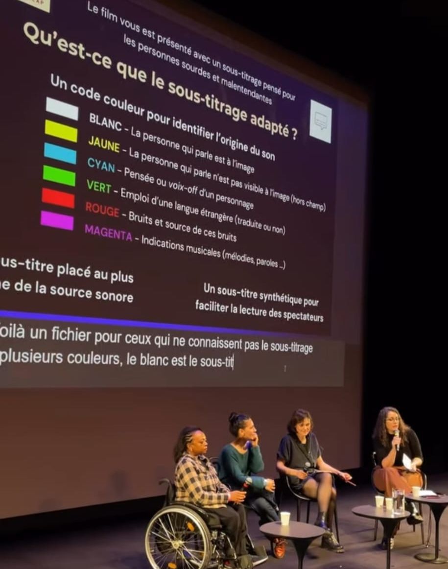 Une table ronde, sur l'écran s'affiche une explication sur le sous-titrage adapté